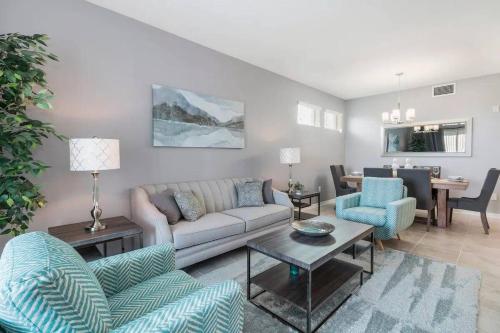 a living room with a couch and two chairs at 3 Bedrooms 2 Bathrooms Storey Lake 4751-308 CT in Orlando