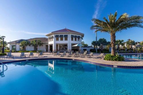 a swimming pool in front of a house at 3 Bedrooms 2 Bathrooms Storey Lake 4751-308 CT in Orlando