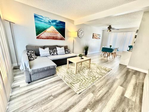 a living room with a couch and a table at Beautiful home near Disneyland. Entire place! in Orange
