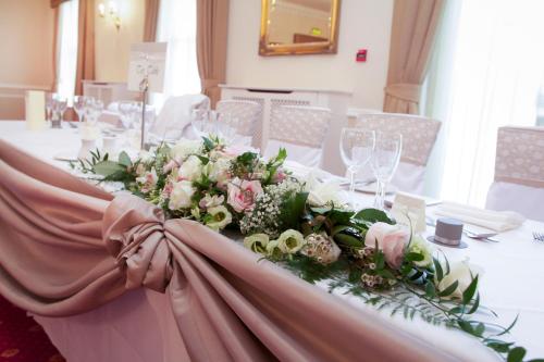 a table with a bunch of flowers on it at Farington Lodge Hotel in Preston
