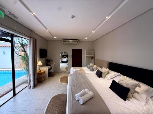 a bedroom with two beds and a pool at Casa KOMU in Asunción