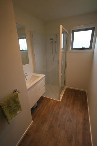 a bathroom with a shower and a sink at Cedar Cottages Blackmans Bay in Kingston