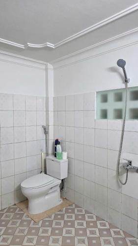 a bathroom with a toilet and a shower at Rose House - Quảng Bình in Bố Trạch