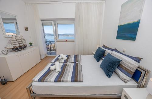 a bedroom with a large bed with blue pillows at Casa Vita in Dramalj