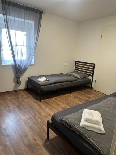 a bedroom with two beds and a window at R&B pension in Ichenhausen