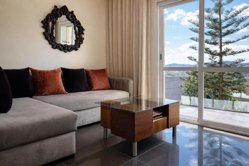 a living room with a couch and a table at Luxury Villa, 3 Levels, 5 bedrooms, 5 Baths, Pool & Garden in Tétouan