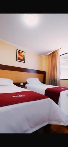a group of beds in a hotel room at Kaypi Yireh in Cabanaconde