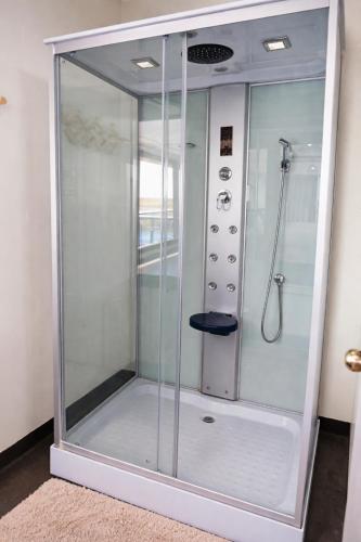 a shower with a glass enclosure in a room at Uros Killa Lodge in Puno