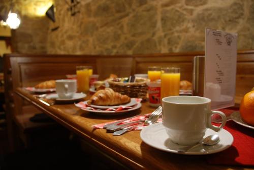 a table with plates of food and cups of coffee at Hotel Zámeček Pod Hradem Starý Jičín 111 in Starý Jičín