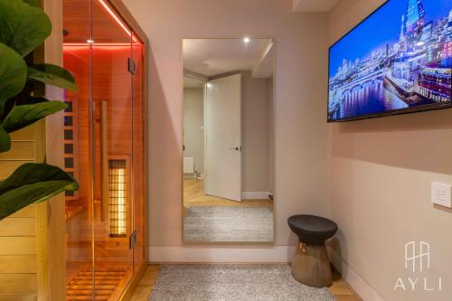 a hallway with a tv on the wall at AYLI - Kensington in London