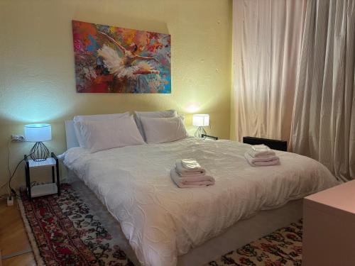 a bedroom with a bed with two towels on it at Timeless Apartment in Delčevo