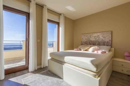 a bedroom with a large bed and a large window at Apartment in Hreljin 39448 in Hreljin