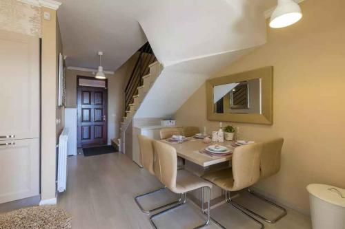 a dining room with a table and chairs and a staircase at Apartment in Hreljin 39448 in Hreljin