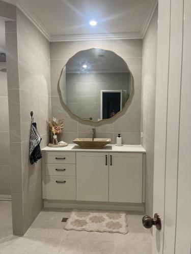 a bathroom with a sink and a mirror at Coastal Calm Seascapes unit 3 in Falcon