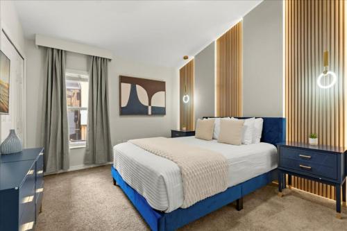 a bedroom with a blue and white bed and a window at 5 Bedrooms 3 Bathrooms Veranda Palms 4458 NP in Orlando