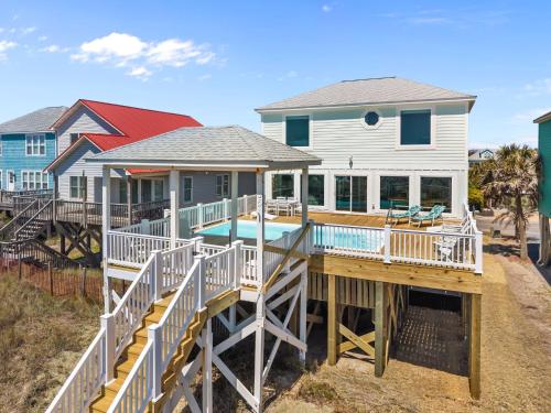 a house with a deck and a swimming pool at Oceanfront Luxury Private Steps to Beach New in Oak Island