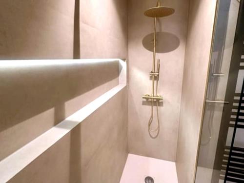 a bathroom with a shower with a glass door at Luxury apartment with sea view in Westende-Bad