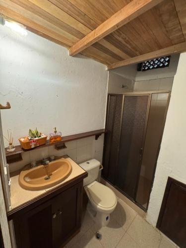 a bathroom with a toilet and a sink and a shower at Hospedaje Casa Renasiente - Guest house in Cali