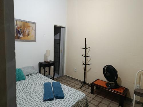 a bedroom with a bed with blue towels on it at Suites Dupla beira mar Carapibus in Conde