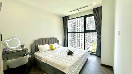 a bedroom with a bed with a flower on it at 2 Giường view Bể bơi Family Room with Pool view in Long Bình