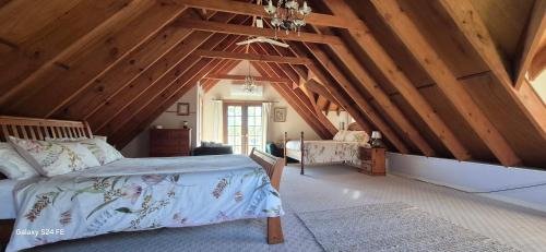 a bedroom with a bed in a room with wooden ceilings at Firefly Resort in Firefly