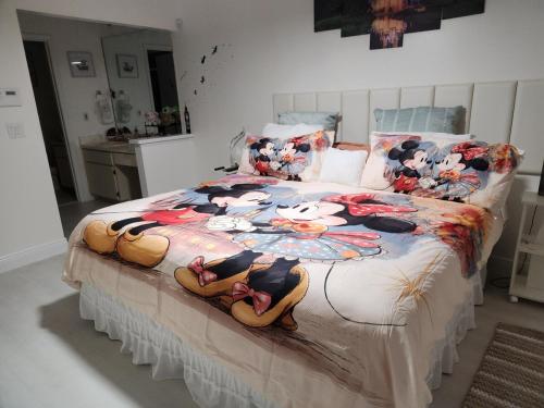 a bedroom with a large bed with dolls on it at 2 Cute 2 Pass UP in Orlando