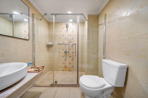 a bathroom with a shower and a toilet and a sink at Kaboting Hotel Chongqing Prime Location Near Jiefangbei & Hongya Cave, 1 Minute Walk to Metro, Ideal for International Guests,Free Self-Service Laundry, Free High-Speed WiFi,Free Chinese Tea, Free Travel Advice in Chongqing