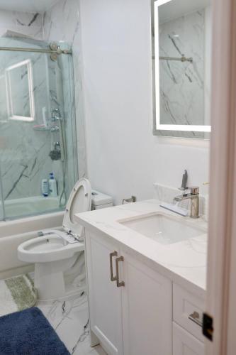 a bathroom with a sink and a toilet and a shower at Comfortable Private Room in Toronto