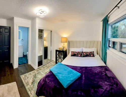a bedroom with a large bed and a window at Private Bedroom with Ensuite in Toronto