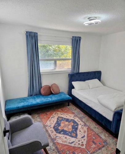 a bedroom with a blue bed and a window at Comfortable Private Room in Toronto