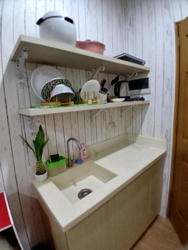 a kitchen with a sink and some shelves at Sol house in Pajak