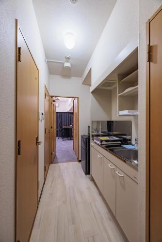 a kitchen with wooden floors and a long hallway at Work Friendly Room 3 min to Station Simmons Bed WiFi and Desk in Nagoya