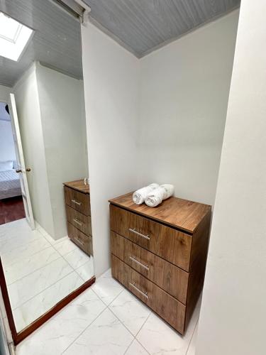 a bathroom with a wooden dresser in a room at Hotel Alamos del Bosque in Pereira