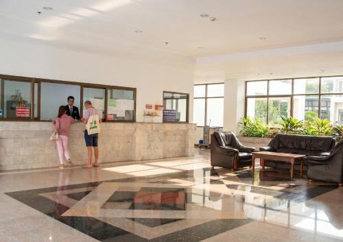 two people standing in the lobby of a building at View Talay 3 Apartment in Pattaya South