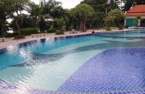 a large swimming pool with blue water at View Talay 3 Apartment in Pattaya South