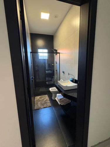 a bathroom with a sink and a toilet at New House, Long Stay in Maringá