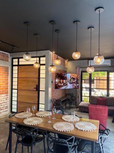 a dining room with a table with wine glasses on it at El marqués casa boutique in Ríohacha