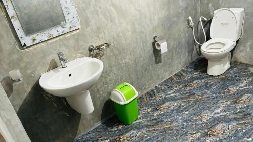 a bathroom with a sink and a toilet at Surf Paradise in Tangalle
