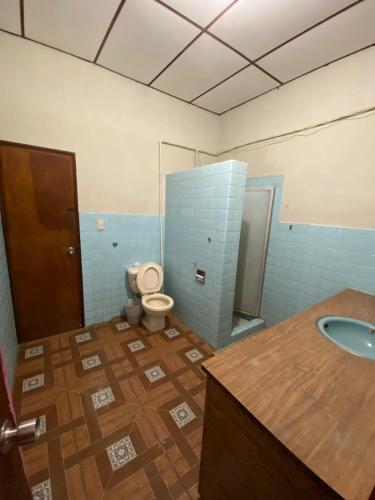 a bathroom with a toilet and a sink at Hostal Casa Colonial in Santa Ana
