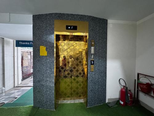 a elevator with a gold door in a room at Hotel Seven View in Bāiljuri