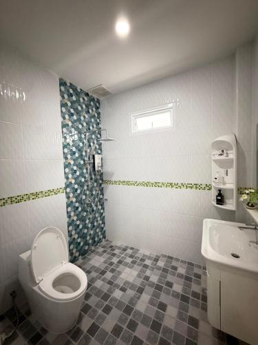 a bathroom with a toilet and a sink at Aroyapoolvilla69 in Ban Yep Chaeng