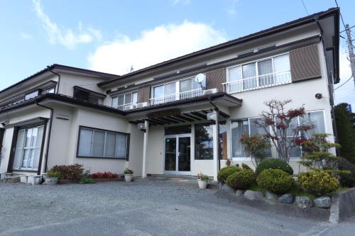 a large white house with a lot of windows at Fujimien in Fujikawaguchiko