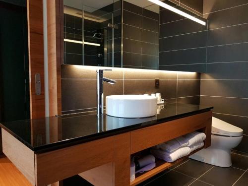 a bathroom with a sink and a mirror at Walden Hotel in Yilan City