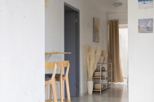 a room with two chairs and a table at Maysi apartments in Willemstad
