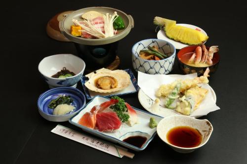 a table with plates of food and bowls of food at Fujimien in Fujikawaguchiko