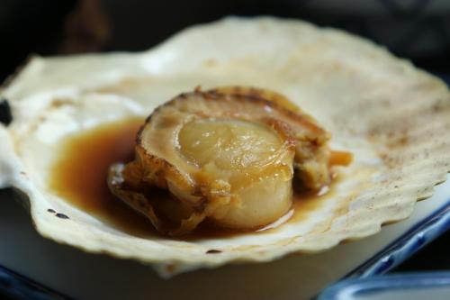 a piece of food is sitting in a tortilla at Fujimien in Fujikawaguchiko