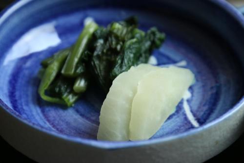 a blue bowl of food with green vegetables in it at Fujimien in Fujikawaguchiko