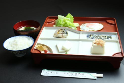 a plastic lunch box with sushi and rice and chopsticks at Fujimien in Fujikawaguchiko