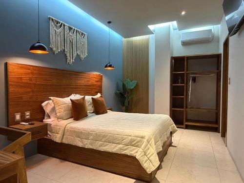 a bedroom with a large bed and blue lighting at Casa Bocobá in Oaxaca City