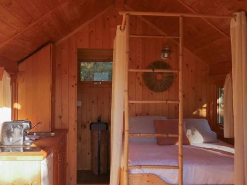 a bedroom with a bunk bed in a cabin at Cabane cosy pour 2 avec jacuzzi - API-1-52-2485 in Saint-Amand-de-Coly
